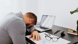 An overworked employee experiencing burnout due to poor work-life balance.